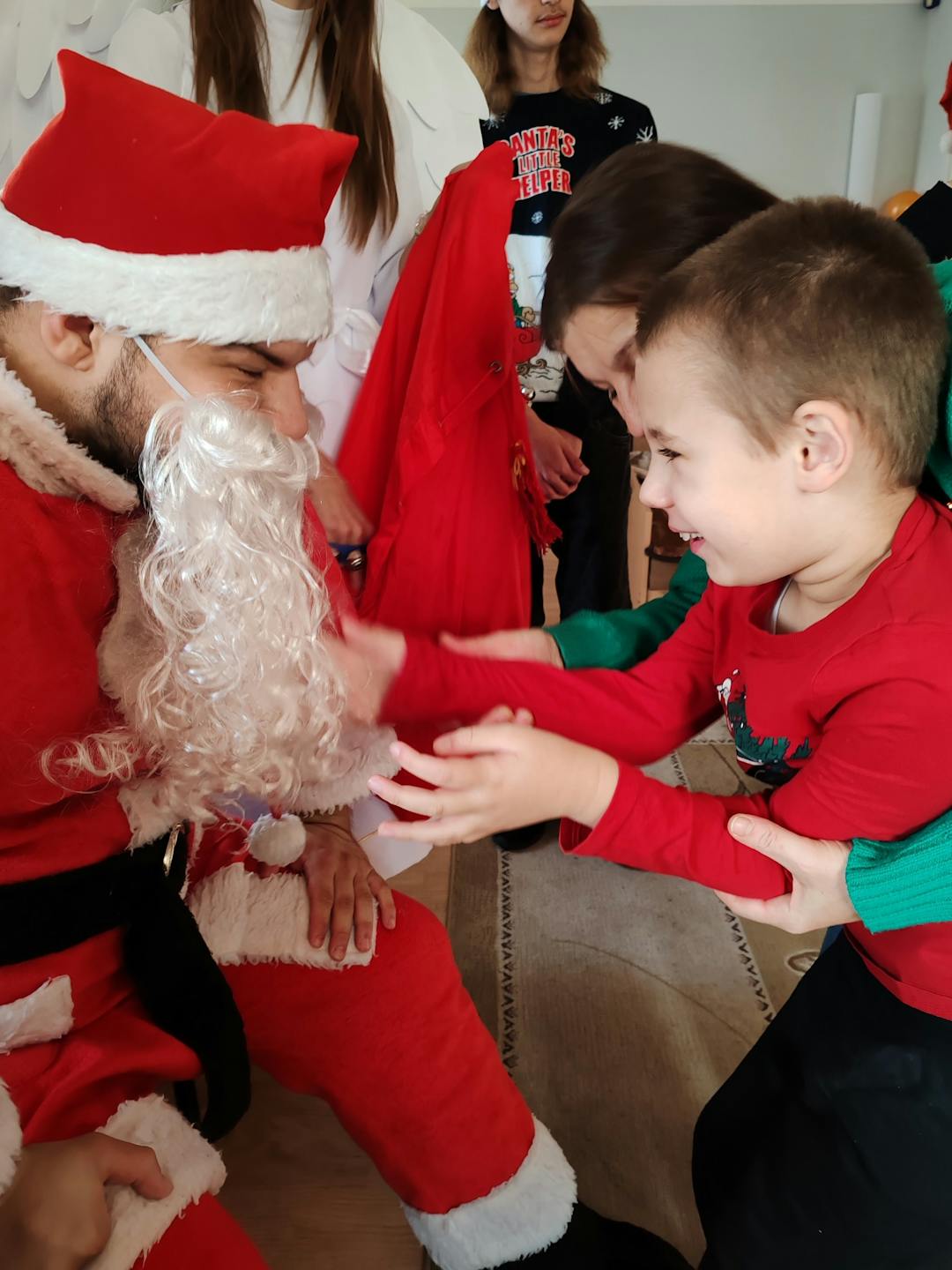 Niezapomniane spotkanie z Mikołajem! | Chłopiec wyciąga ręce do Mikołaja.jpg
