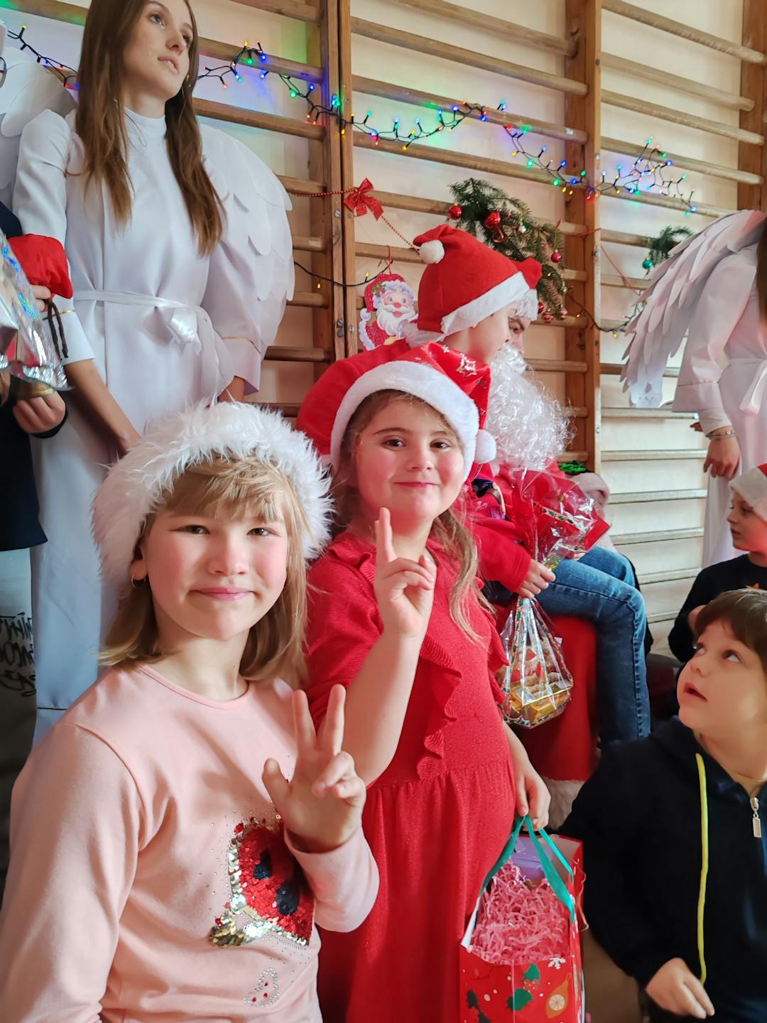 Niezapomniane spotkanie z Mikołajem! | Dwie uśmiechnięte dziewczynki pozują do zdjęcia .jpg