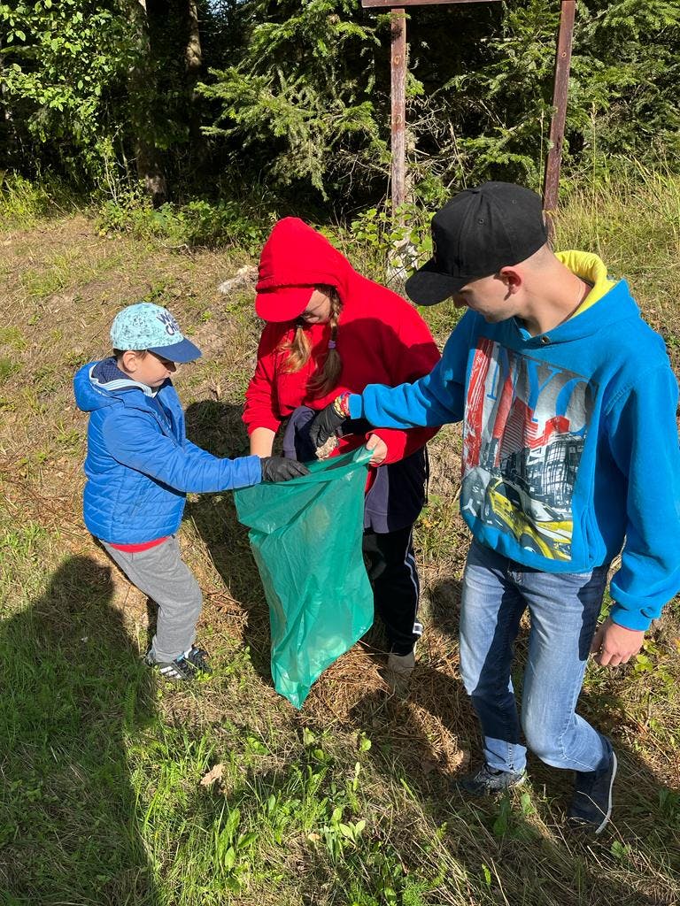 W rezerwacie przyrody Jedlina | dzieci z workiem na śmieci w tle las.jpg