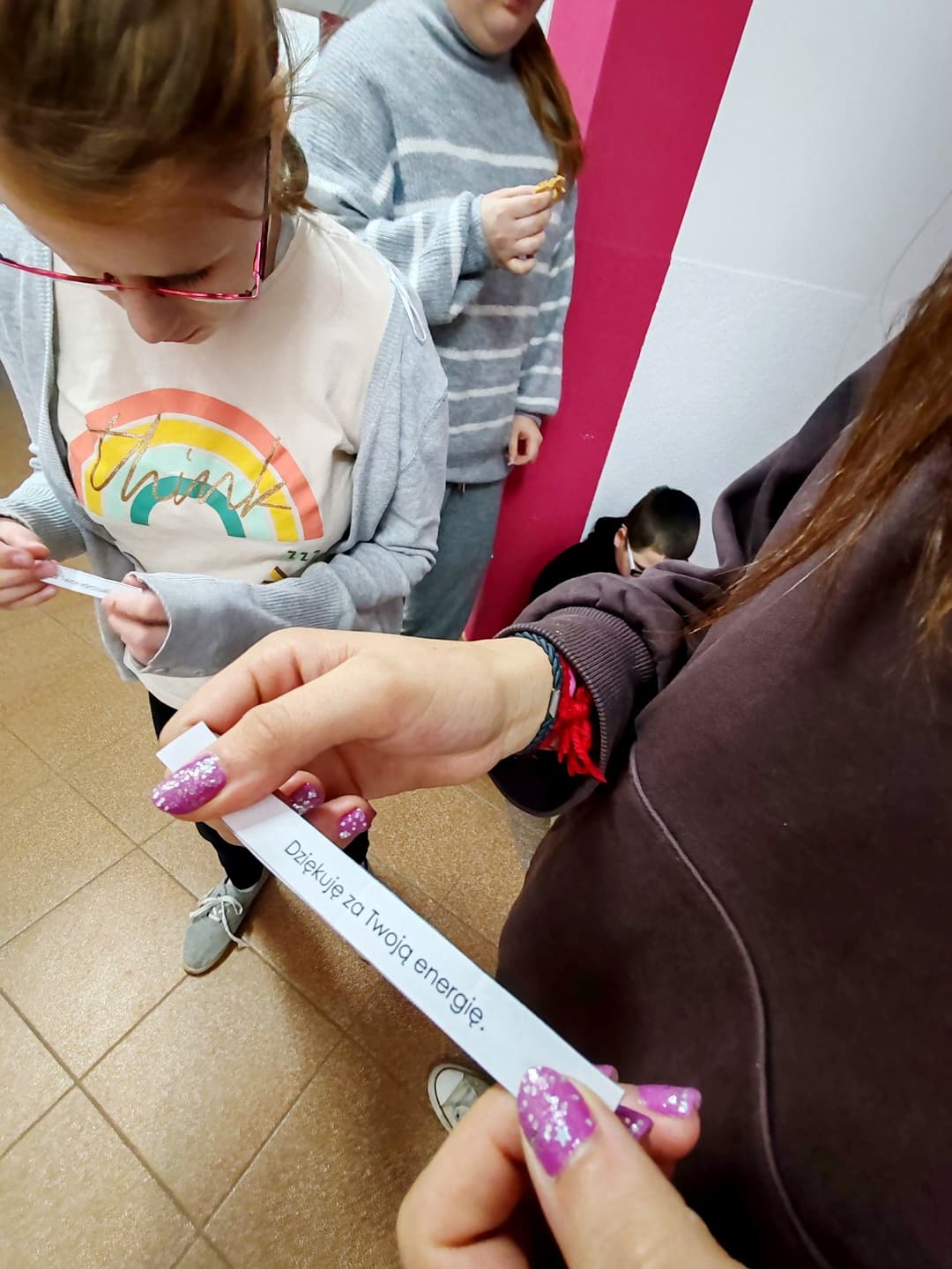 Dzień Życzliwości i Pozdrowień | uczennica trzyma w rękach kartke z pozdrowieniem.jpg