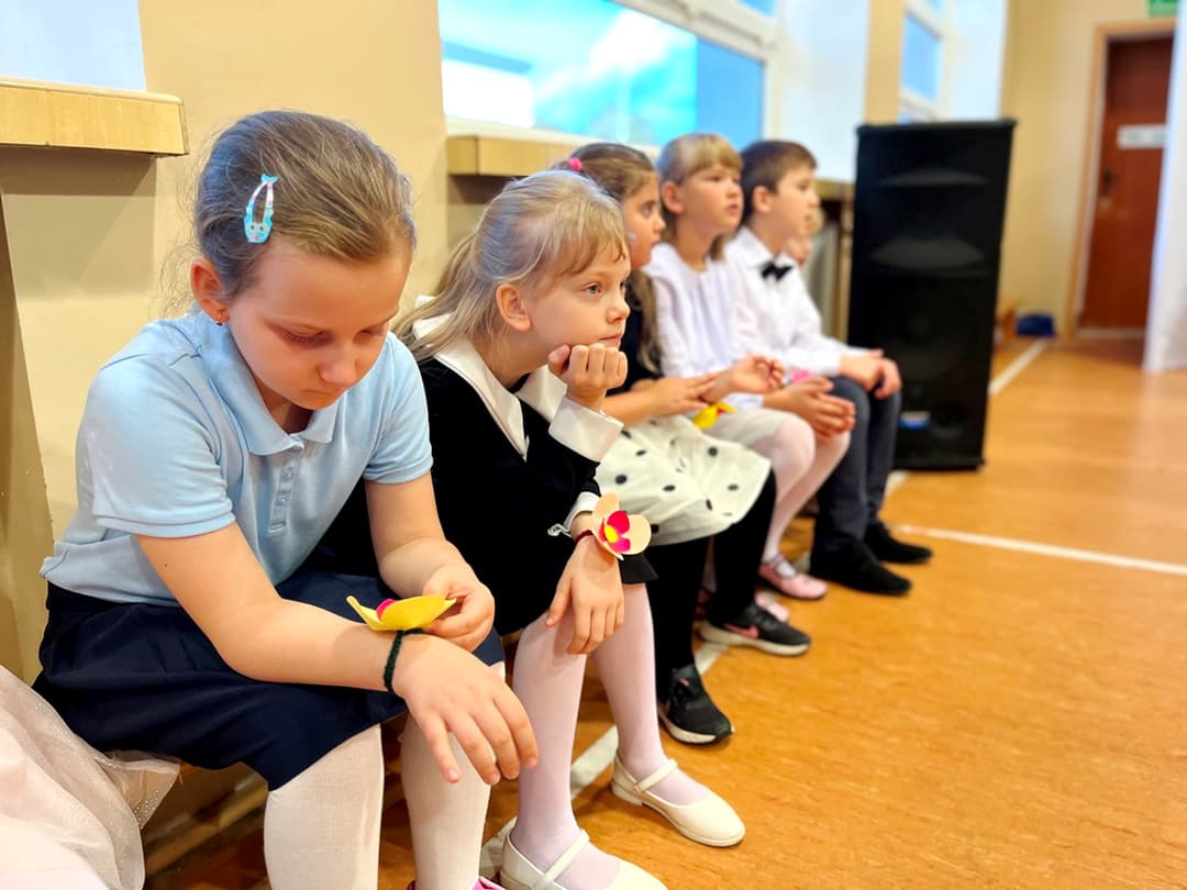 Świętujemy Dzień Edukacji Narodowej | uczniowie siedzą na ławeczce i czekają na występ.JPG